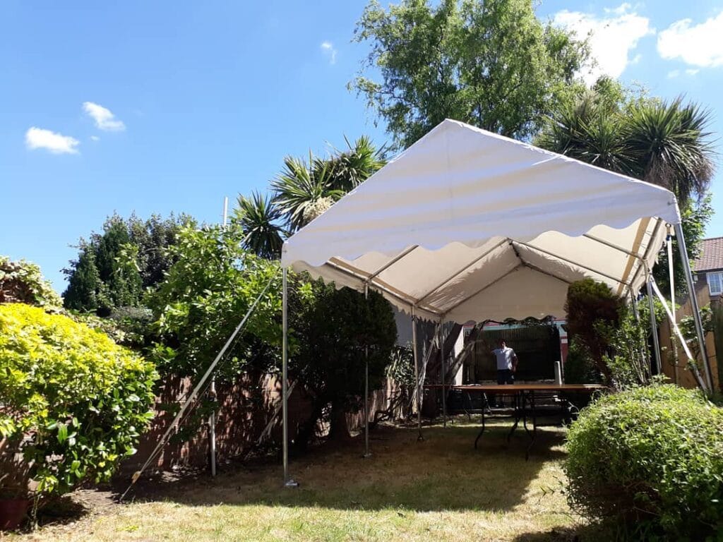 3x6m Marquee erected with a tree and bushes inside for effect